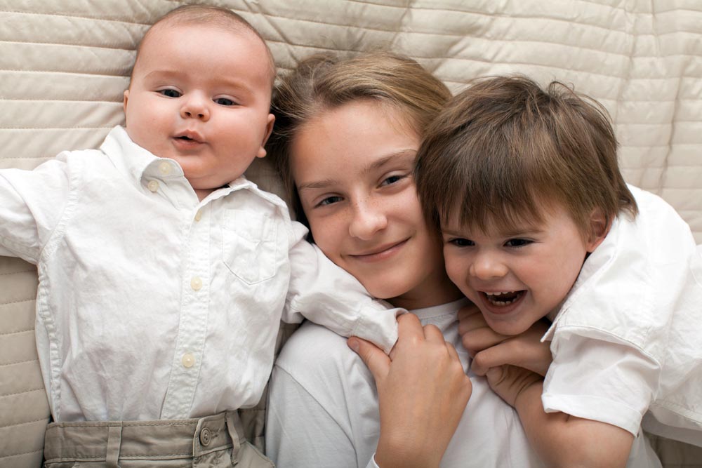 Cute happy Caucasian siblings expressing happiness.